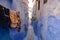 Blue historical streets of Morocco. Narrowest street and hanging laundry.