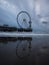 Blue hour beach water reflection panorama of sky view ferris wheel on pier of Scheveningen The Hague Netherlands Europe