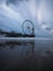 Blue hour beach water reflection panorama of sky view ferris wheel on pier of Scheveningen The Hague Netherlands Europe