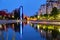 Blue hour light reflections in the city, on Dambovita river, in Bucharest, Romania. Tall building Chamber of Commerce and Industry