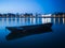 Blue hour on Sava river, promenade in Slavonski Brod and blurred boat in front