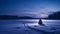 Blue Hour Snowmobile Ride: A Romanticized Depiction Of Wilderness