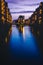 Blue hour in Warehouse District - Speicherstadt with lilac colored sky. Tourism landmark Wandrahmsfleet in twilight