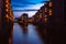 Blue hour in Warehouse District - Speicherstadt. Tourism landmark of Hamburg in twilight. View of Wandrahmsfleet in