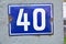 A blue house number plaque, showing the number forty