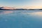 Blue ice of the frozen lake at morning. Winter landscape in the mountains and the winter road in Yakutia, Siberia, Russia