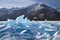 Blue ice hummocks on mountains background