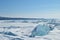 The blue ice of Lake Baikal. Baikal in winter. Transparent and clean ice of Lake Baikal.