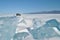 The blue ice of Lake Baikal. Baikal in winter. Transparent and clean ice of Lake Baikal.