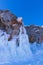 Blue ice waterfall on Ogoy Island in the Maloye More Strait on Lake Baikal on a sunny winter day. Siberia, Russia