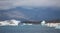 Blue icebergs, lagoon and tourist boat