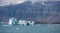 Blue icebergs, lagoon and tourist boat