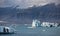 Blue icebergs, lagoon and tourist boat