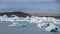 Blue icebergs, lagoon and tourists