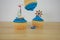 Blue iced cup cakes with mini boat decorations