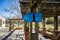 Blue information wooden sign on a wooden sun shade