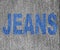 Blue Inscription Jeans over grey jeans texture
