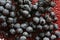 Blue isabella grape clusters on the glass plate