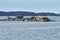 Blue Isolated cottage in a rocky island at the Thousand Islands. Ontario, Canada