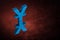 Blue Japanese of Chinese Currency Symbol or Sign With Mirror Reflection on Red Dusty Background