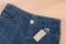 Blue jean with price tag on wood background
