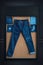 Blue jeans on a brown wooden background.