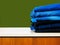 Blue jeans isolated on green background. Jeans stacked on a light background. Jeans background. Stack of clothing  close up.