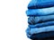 Blue jeans isolated on white background. Jeans stacked on a light background. Jeans background. Stack of clothing  close up, top v