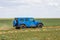 Blue Jeep Wrangler Rubicon Unlimited in steppe near Utta village.