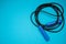 Blue Jumping rope on blue background. Top view. Free copy space for text
