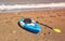 Blue kayak lying on the sandy beach