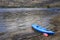 Blue kayak moored at Loch Lomond on island