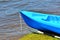 Blue kayak on river bank
