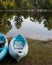 Blue Kayaks on grassy shore near large lake