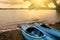 Blue Kayaks on the Lake Shore with Sun Rays