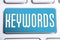 Blue Keywords Button On A White Keyboard