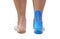 Blue kinesiology taping on pain women foot on white background