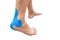 Blue kinesiology taping on pain women leg on white background