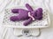 A blue knitted teddy bear lies on an electronic baby scale on a diaper with asterisks