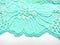 Blue lace fabric on white background from above