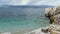 Blue lagoon beach coast, Kassiopi village, Corfu Island, Greece. Rocky coast of Ionian Sea with clear turquoise water