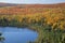 Blue lake amid colorful fall trees in Minnesota