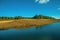 Blue lake on landscape of rural lowlands