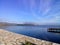 Blue lake of Mesologi, Aetolia Acarnania, Greece on a misty day. View of the pier for fishing boats.