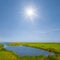 Blue lake among prairies under a sparkle sun