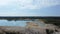 Blue lake among rock dumps of ilmenite quarry, aerial view