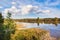 Blue lake under cloudy sky with clouds reflection scenic view