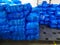 Blue laundry bags with clothes stored on pallets