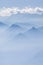 Blue layers of mountain ridges in the french alps with clouds