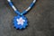 Blue Leather anBlue Leather and Pink Sunburst pendant on a Blue and Silver Chain